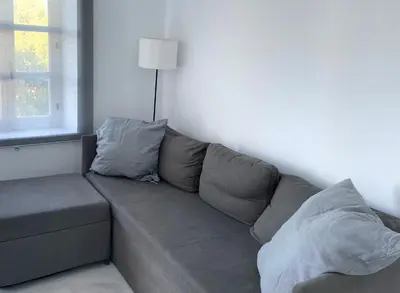 a gray couch in a living room with a window at Apartamento Canalejas in Cádiz