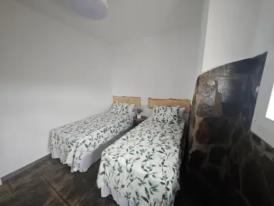 two beds sitting next to each other in a room at Villa Rural Nuestro Rincón in Sanlúcar de Barrameda