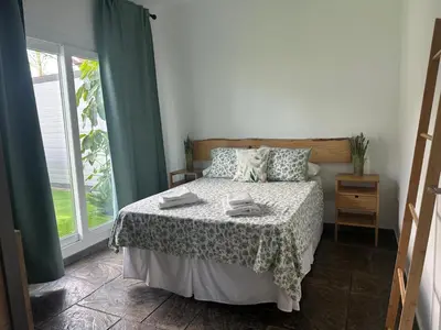 a bedroom with a bed and a window at Villa Rural Nuestro Rincón in Sanlúcar de Barrameda