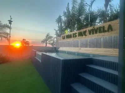 a swimming pool with the sunset in the background at Villa Rural Nuestro Rincón in Sanlúcar de Barrameda