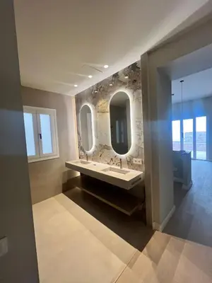 a bathroom with two sinks and two mirrors at Torre Camelia Adults recommended in Cádiz