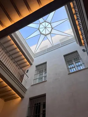 a large glass ceiling in a building with windows at Torre Camelia Adults recommended in Cádiz