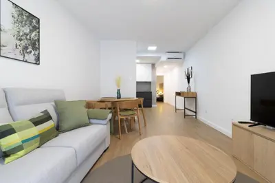 a living room with a couch and a table at Allo Apartments Balderrama Parking Centro 1 Habitación in Jerez de la Frontera