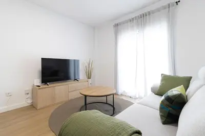 a living room with a couch and a tv at Allo Apartments Balderrama Parking Centro 1 Habitación in Jerez de la Frontera