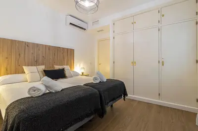 a bedroom with a large bed with towels on it at Allo Apartments Balderrama Parking Centro 1 Habitación in Jerez de la Frontera