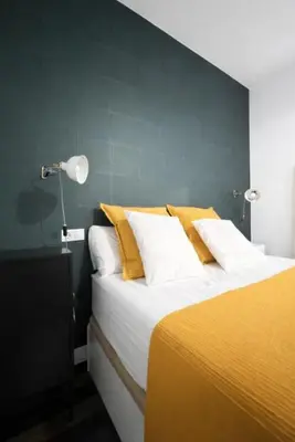 a bedroom with a large bed in a room at Solera y Mar, Apartamentos Living Sur in Sanlúcar de Barrameda