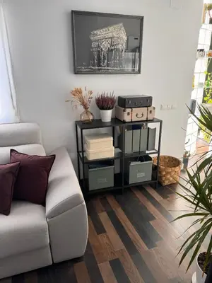 a living room with a white couch and a table at Solera y Mar, Apartamentos Living Sur in Sanlúcar de Barrameda