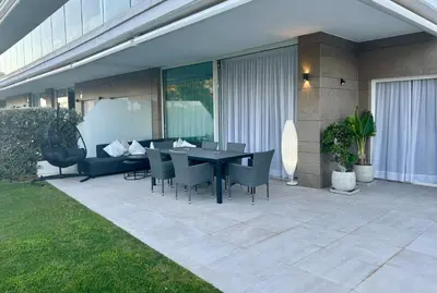 a patio with a black table and chairs at Eleven Views in Chipiona