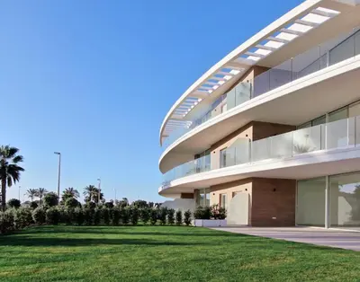 a building with a green lawn in front of it at Eleven Views in Chipiona