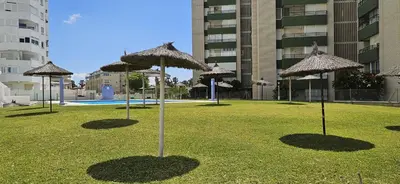 a group of umbrellas sitting in a grass field at Valparaiso Arenas in El Puerto de Santa María