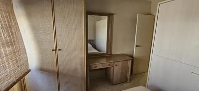 a small bedroom with a mirror and a bed at Valparaiso Arenas in El Puerto de Santa María