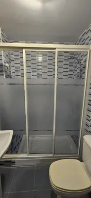 a bathroom with a shower with a toilet and a sink at Valparaiso Arenas in El Puerto de Santa María