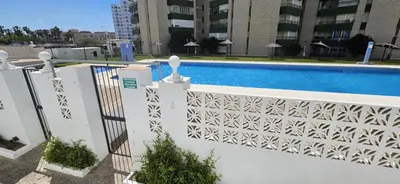 a white fence next to a swimming pool at Valparaiso Arenas in El Puerto de Santa María