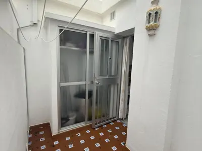 a balcony with a glass door on the side of a building at García Rota Beach by staycare in Rota