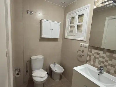a bathroom with a toilet and a sink at García Rota Beach by staycare in Rota