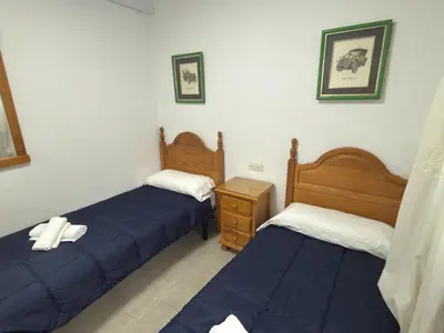 a bedroom with two beds and a nightstand at García Rota Beach by staycare in Rota