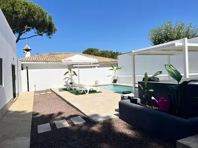 a backyard with a swimming pool and a house at Villa Verano in Novo Sancti Petri