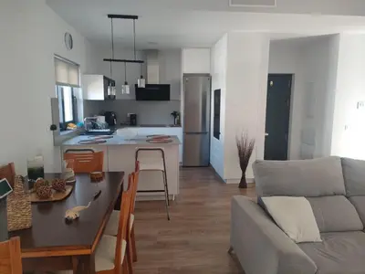 a kitchen and living room with a couch and a table at Villa Verano in Novo Sancti Petri