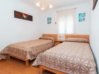 a room with two beds in a room at Winahost El Rincon del Puerto in El Puerto de Santa María