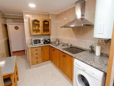 a kitchen with a sink and a microwave at Winahost El Rincon del Puerto in El Puerto de Santa María