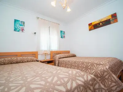 a bedroom with two beds and a window at Winahost El Rincon del Puerto in El Puerto de Santa María