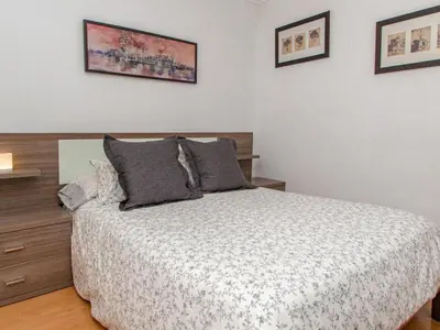 a bedroom with a bed and some pictures on the wall at Winahost El Rincon del Puerto in El Puerto de Santa María