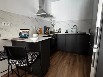 a kitchen with a counter with a laptop on it at Apartamento cerca del paseo marítimo in Rota