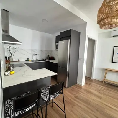 a kitchen with a counter and a refrigerator at Apartamento cerca del paseo marítimo in Rota
