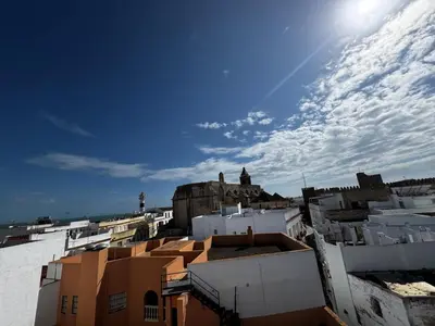 a view of a city from the roofs of buildings at Apartamento cerca del paseo marítimo in Rota