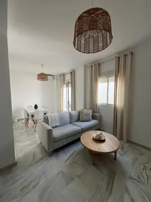 a living room with a couch and a table at Apartamento Relax Centro in Sanlúcar de Barrameda