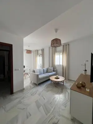 a living room with a couch and a table at Apartamento Relax Centro in Sanlúcar de Barrameda