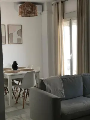 a living room with a couch and a table at Apartamento Relax Centro in Sanlúcar de Barrameda
