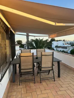 a living room with a couch and a tv at Villa Palmeras in Conil de la Frontera
