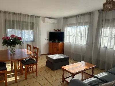 a large white house with a large yard at Villa Palmeras in Conil de la Frontera