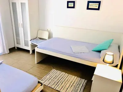 a small bedroom with a bed and a chair at casa jaramar in Sanlúcar de Barrameda