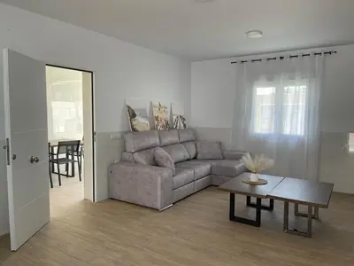 a living room with a couch and a table at Jaimar12 in Novo Sancti Petri