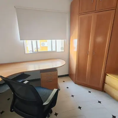 a office with a desk and a chair and a cabinet at Casa Álamo in Puerto Real