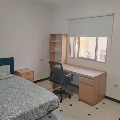 a bedroom with a desk and a bed and a chair at Casa Álamo in Puerto Real