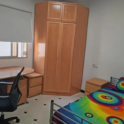 a bedroom with a desk and a bed and a cabinet at Casa Álamo in Puerto Real