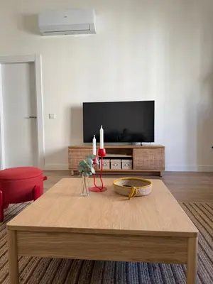 a living room with a coffee table and a flat screen tv at ESPECTACULAR PISO EN PALACIO Preferiblemente familias y mayores de treinta años in El Puerto de Santa María