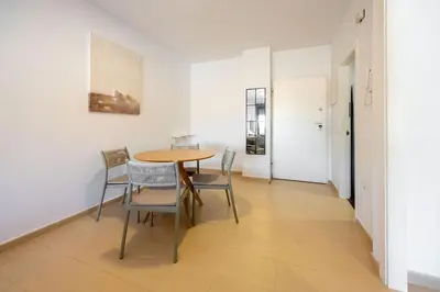 a dining room with a table and chairs at Centro con piscina y cerca de la estación de tren in El Puerto de Santa María