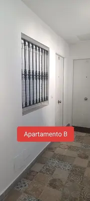 a red sign that saysarmaarma on a white room at Apartamento Prieta in Jerez de la Frontera