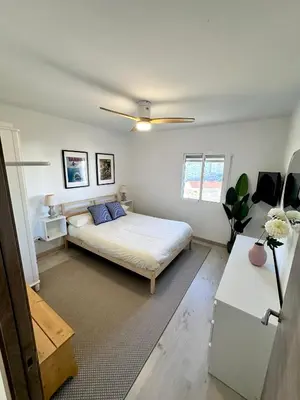 a bedroom with a bed and a ceiling fan at Atreb San Fernando in San Fernando