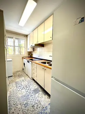 a kitchen with white cabinets and a tile floor at MyChoice La Forestal in Rota