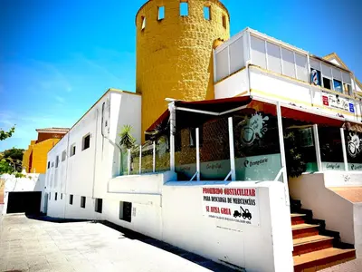 a building with a clock tower on top of it at MyChoice La Forestal in Rota