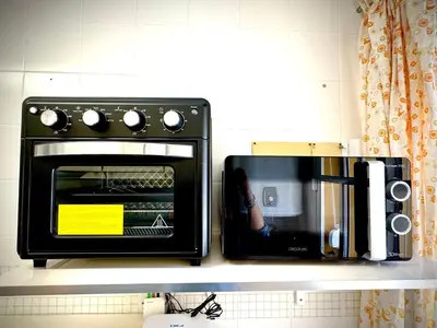 a toaster oven sitting on a shelf in a kitchen at MyChoice La Forestal in Rota