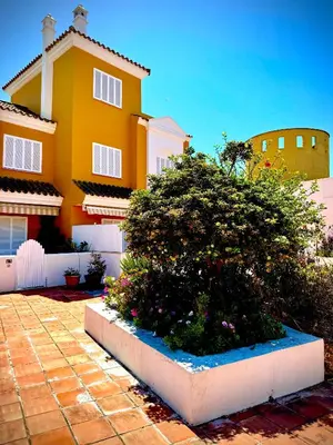 a yellow house with a bush in front of it at MyChoice La Forestal in Rota