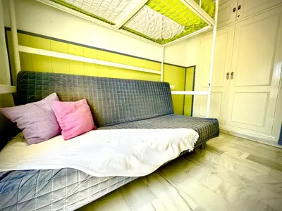a bed with two pink pillows on it in a room at MyChoice La Forestal in Rota