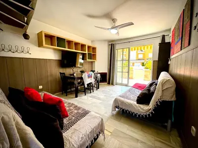a bedroom with a bed and a dining room at MyChoice La Forestal in Rota