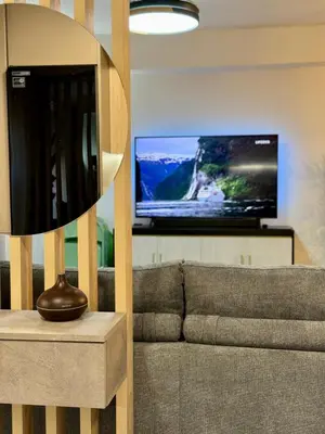 a living room with a couch and a flat screen tv at Apartamento Guadalquivir 34 in Sanlúcar de Barrameda